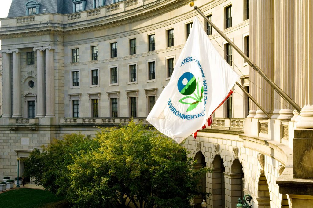 The EPA flag flying on the front of the EPA headquarters building