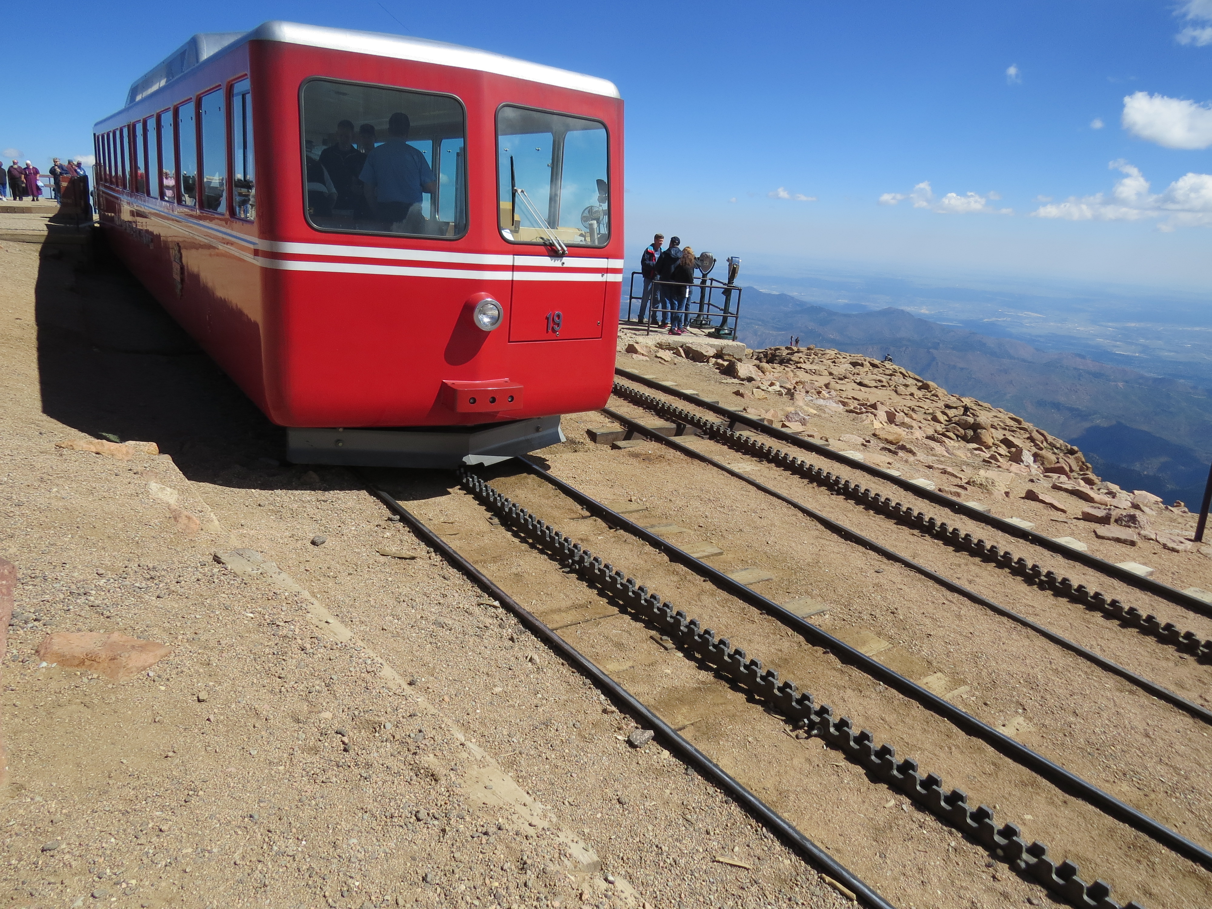 Cog train at Pikes Peak, CO.  A cog train can travel up grades greater than 10%.  The Pikes Peak Cog Train's greatest ascent is 25% grade. A new cog train is to be completed sometime in 2021. 