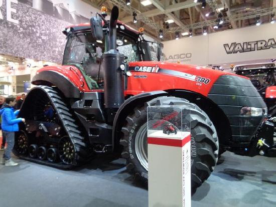 A Case IH tractor with triangle-shaped rear wheels. The tractor itself is about the size of three sedans.