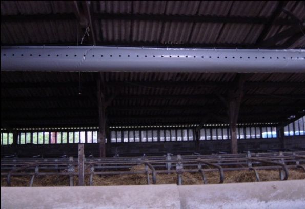 The ground view of a ceiling-height duct used to disperse a tracer gas in an animal house.