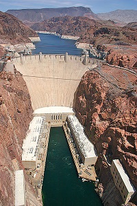A dam in a river, with an extremely large drop in the water level downstream of the dam compared to upstream.