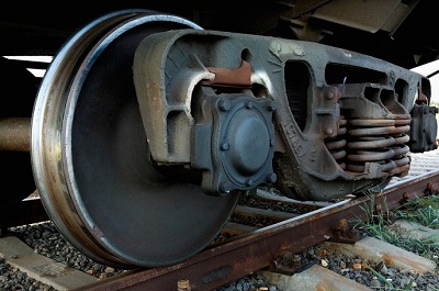 Close-up of a train wheel as the train moves along a track.