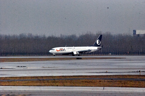 A plane moving along a runway.
