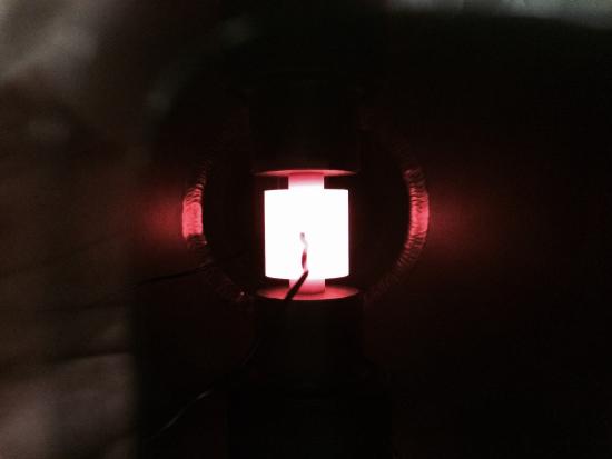 Figure 3. Graphite die with thermocouple inserted during spark plasma sintering (SPS) of a thermoelectric (Photo taken by author). SPS is a consolidation technique where powdered material is pressed while current is passed through the die. The resistance of the die and material results in heating, which can programmed to specific temperatures by the instrument.